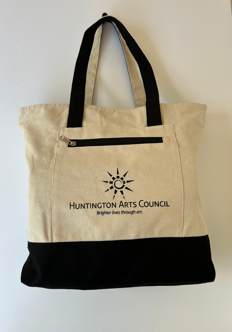 Product Description: Canvas tote bag with zippered closures. HAC logo screenprinted on pocked in black.</br> HAC Tote