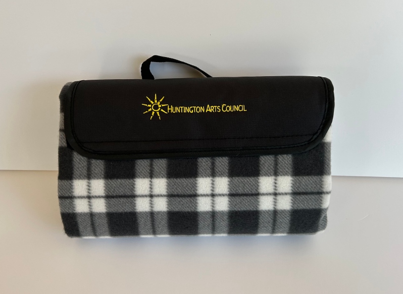 Product Description: Gray and white flannel roll up picnic blanket. HAC logo embroidered in yellow on flap. Blanket size 53" x 47" or 12" x 6.5" when rolled.</br> HAC Picnic Blanket